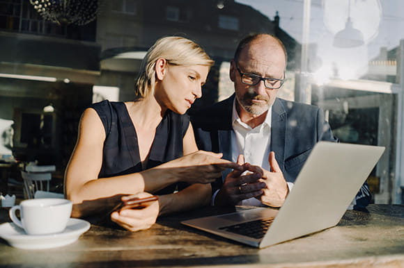 Two business owners working at a laptop