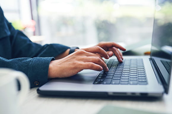 Someone working on a laptop