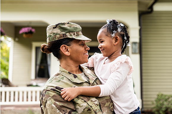 Female solider holding her child