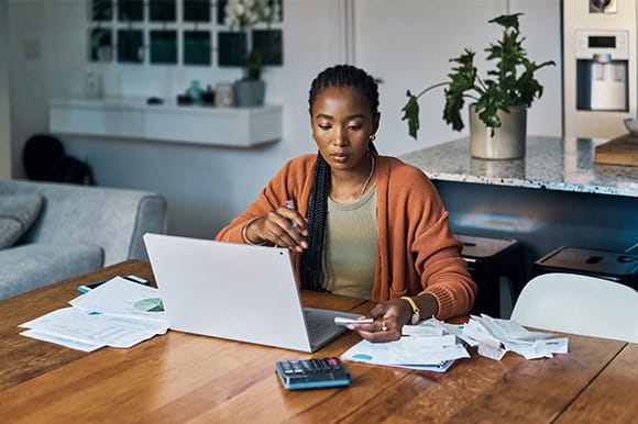 A woman doing paperwork in her home